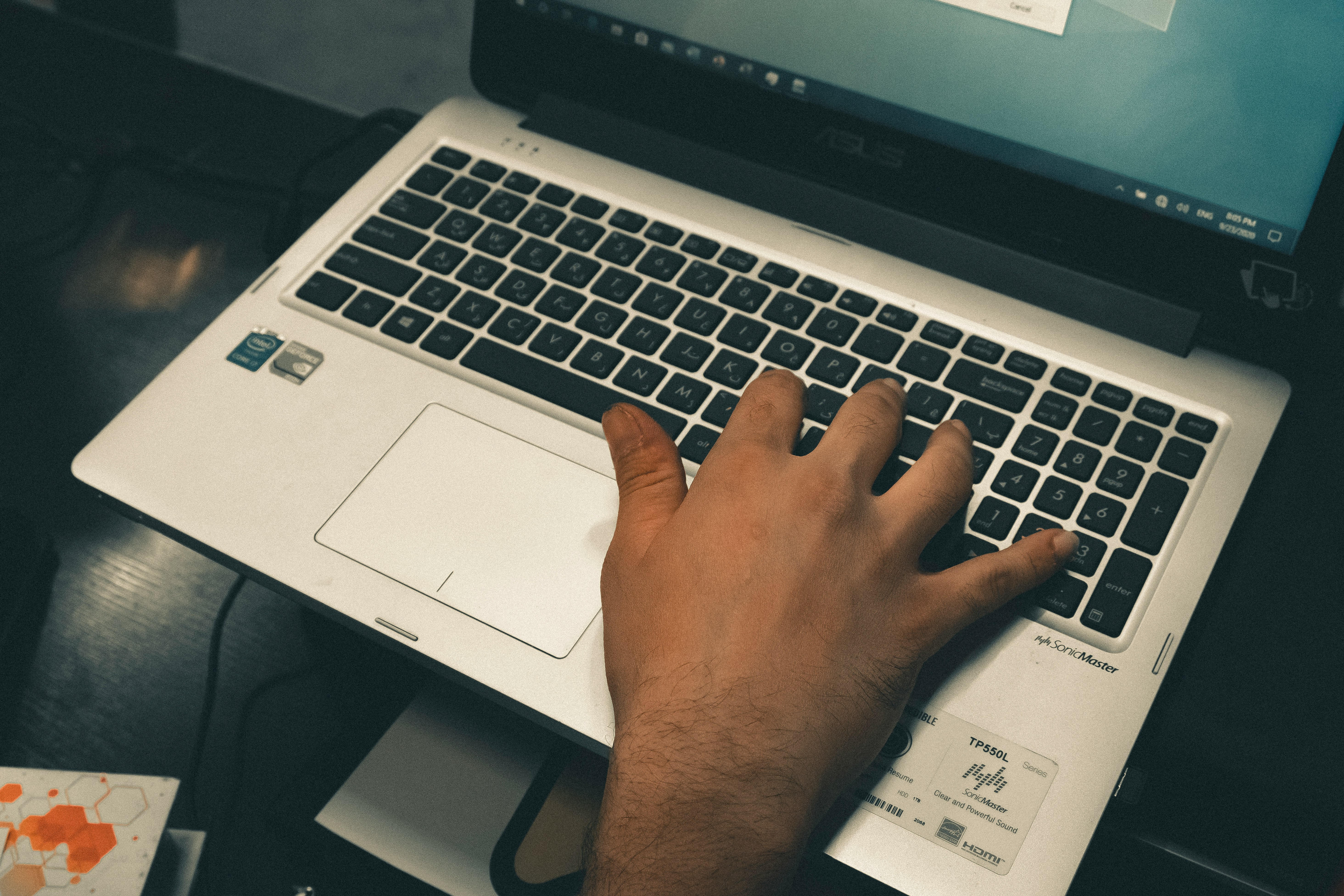 person holding black and silver asus laptop computer